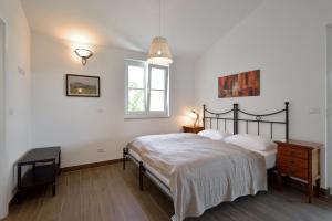 Postel nebo postele na pokoji v ubytování Villa Pomegrana