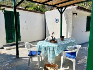 a table and chairs on a patio with a table and a table and chairs at La Cicocca in Portoferraio
