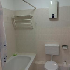 a bathroom with a tub and a toilet and a sink at Amselpark - 38542 in Kellenhusen
