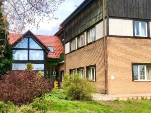 a brick house with a black roof at Folwark Nadmorska Ostoja in Mechelinki