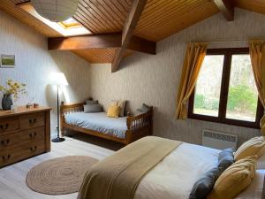 a bedroom with a bed and a dresser and a window at Les Oliviers in Sanguinet