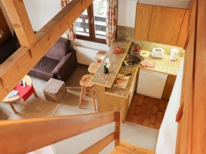 an overhead view of a kitchen and a living room at Apartment Les Arsets 301-11 by Interhome in Arveyes