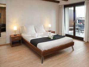 a bedroom with a large bed with flowers on it at Apartment Gamat 30 by Interhome in Villars-sur-Ollon