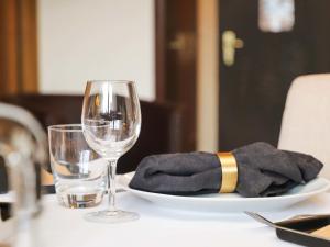 a table with a plate and two wine glasses at Apartment Gamat 30 by Interhome in Villars-sur-Ollon +17 photos