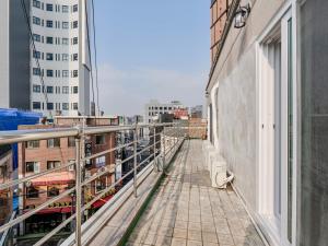 a balcony with a view of a city at Harmony Stay in Seoul