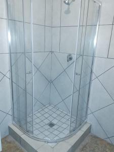 a shower with a glass enclosure in a bathroom at Kgakgamela road lodge in Driekop