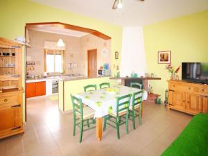 a kitchen and dining room with a table and chairs at Villa Andrea by Interhome in Floridia