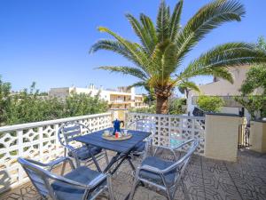 a table and chairs on a balcony with a palm tree at Holiday Home Villa Sol by Interhome in Calpe