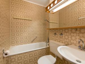 a bathroom with a tub and a toilet and a sink at Apartment B1010 by Interhome in Lahnstein