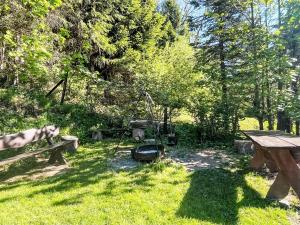 a park with benches and a picnic table in the grass at Holiday Home Karpacz Kowary by Interhome in Kowary