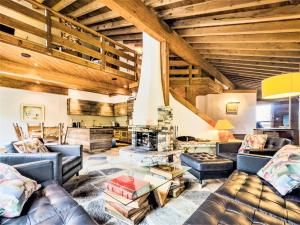 a living room with leather furniture and a wooden ceiling at Holiday Home Les Clèves by Interhome in Nendaz