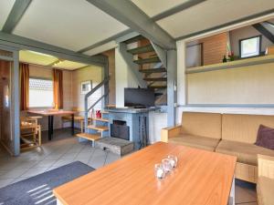 a living room with a couch and a table at Holiday Home Dorf 1-Haus 14 by Interhome in Kirchheim