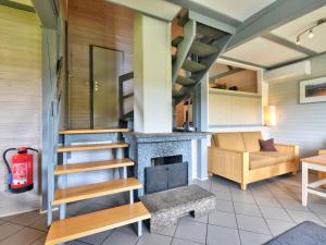 a living room with a staircase and a fireplace at Holiday Home Dorf 1-Haus 14 by Interhome in Kirchheim