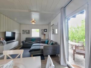 a living room with a couch and a tv at Holiday Home Seepark Kirchheim-8 by Interhome in Kirchheim