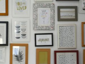 a wall of framed pictures on a wall at Holiday Home Dorf 4-Haus 10 by Interhome in Kirchheim