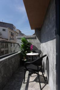 a table and a chair sitting on a balcony at The Aramis Galata Hotel in Istanbul