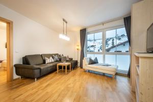 a living room with a couch and a chair at Appartement Haus Faßwald in Obertauern