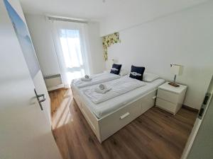 a small white bedroom with a bed and a window at Apartment Vinzek by Interhome in Töschling