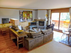 a living room with a couch and a table at Apartment Soldanella by Interhome in Crans-Montana