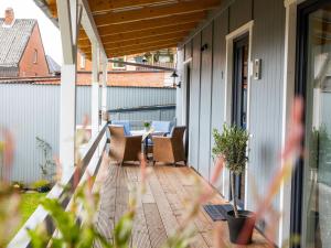 an outdoor porch with chairs and a table at Apartment Nachtigall II-2 by Interhome in Osten
