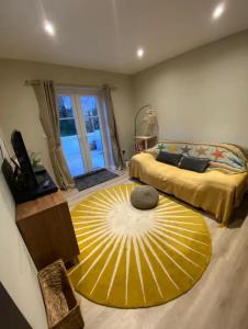 Saint Columb MinorにあるWrens Nestのベッドルーム1室(大型ベッド1台、大きな黄色のラグ付)