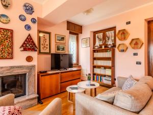 a living room with a couch and a fireplace at Apartment Bruna by Interhome in Gera Lario