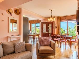 a living room with a couch and a dining room at Apartment Bruna by Interhome in Gera Lario