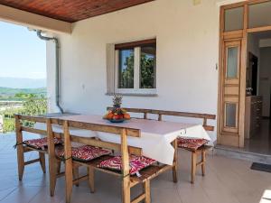 a table and chairs on the porch of a house at Holiday Home Laura by Interhome in Potpićan