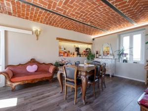 a living room with a table and a couch at Holiday Home Helix1912 by Interhome in San Damiano dʼAsti