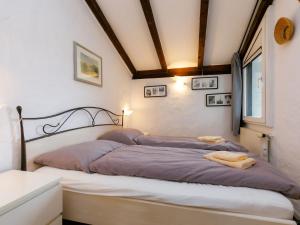 a bedroom with two beds with towels on them at Apartment Villaggio Sureggio - App- C1 by Interhome in Lugaggia