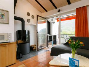 a living room with a fireplace and a television at Apartment Villaggio Sureggio - App- C1 by Interhome in Lugaggia