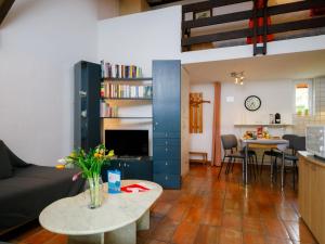 a living room with a couch and a table at Apartment Villaggio Sureggio - App- C1 by Interhome in Lugaggia