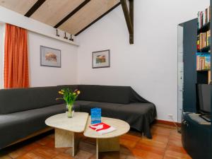 a living room with a couch and a table at Apartment Villaggio Sureggio - App- C1 by Interhome in Lugaggia