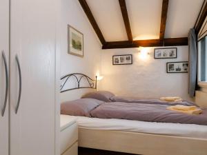 a bedroom with a bed in the corner of a room at Apartment Villaggio Sureggio - App- C1 by Interhome in Lugaggia