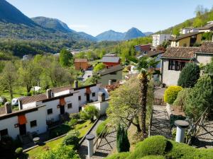 a view of a town with mountains in the background at Apartment Villaggio Sureggio - App- C1 by Interhome in Lugaggia