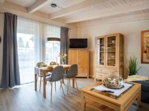 a living room with a table and a dining room at Apartment Nachtigall II-3 by Interhome in Osten