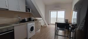 a kitchen with a sink and a washing machine at Tomarhousing - Templar in Tomar