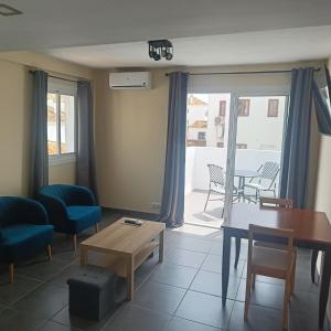 a living room with a table and a couch and a table at Duquesa Harbour Club Aparthotel in Manilva