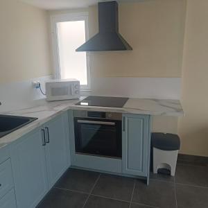 a kitchen with a sink and a stove top oven at Duquesa Harbour Club Aparthotel in Manilva