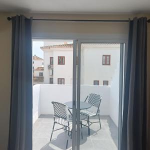 a patio with a table and chairs on a balcony at Duquesa Harbour Club Aparthotel in Manilva
