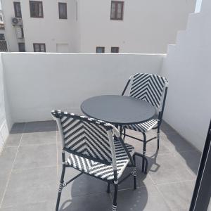 a table and two chairs sitting next to each other at Duquesa Harbour Club Aparthotel in Manilva