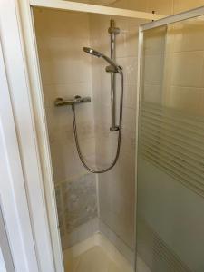 eine Dusche mit Glastür im Bad in der Unterkunft 9 bed house with garden & parking in Iford