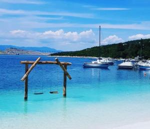 a wooden cross in the water next to boats at Nona - 200m from the beach in Jadranovo