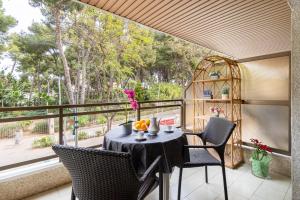 un tavolo e sedie su un balcone con una grande finestra di TuristMar - Amplio Apartamento en Salou con piscina, a 2 minutos de la Playa a Salou