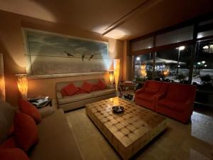 a living room with a couch and a table at Mainalon Resort in Tripolis