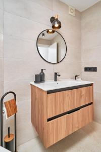 a bathroom with a sink and a mirror at Kanu Apartment - Torrox Costa in Torrox Costa