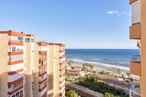 a view of the ocean from the balcony of a building at Kanu Apartment - Torrox Costa in Torrox Costa