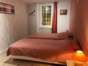 a bedroom with a bed and a window at Le Jardin de Chignore in Vollore-Ville