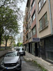two cars parked on a street next to a building at Студио Бургас 2 in Burgas City +10 photos