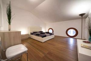 - une chambre avec un lit et deux fenêtres circulaires dans l'établissement Attic floor venice apartment, à Mestre